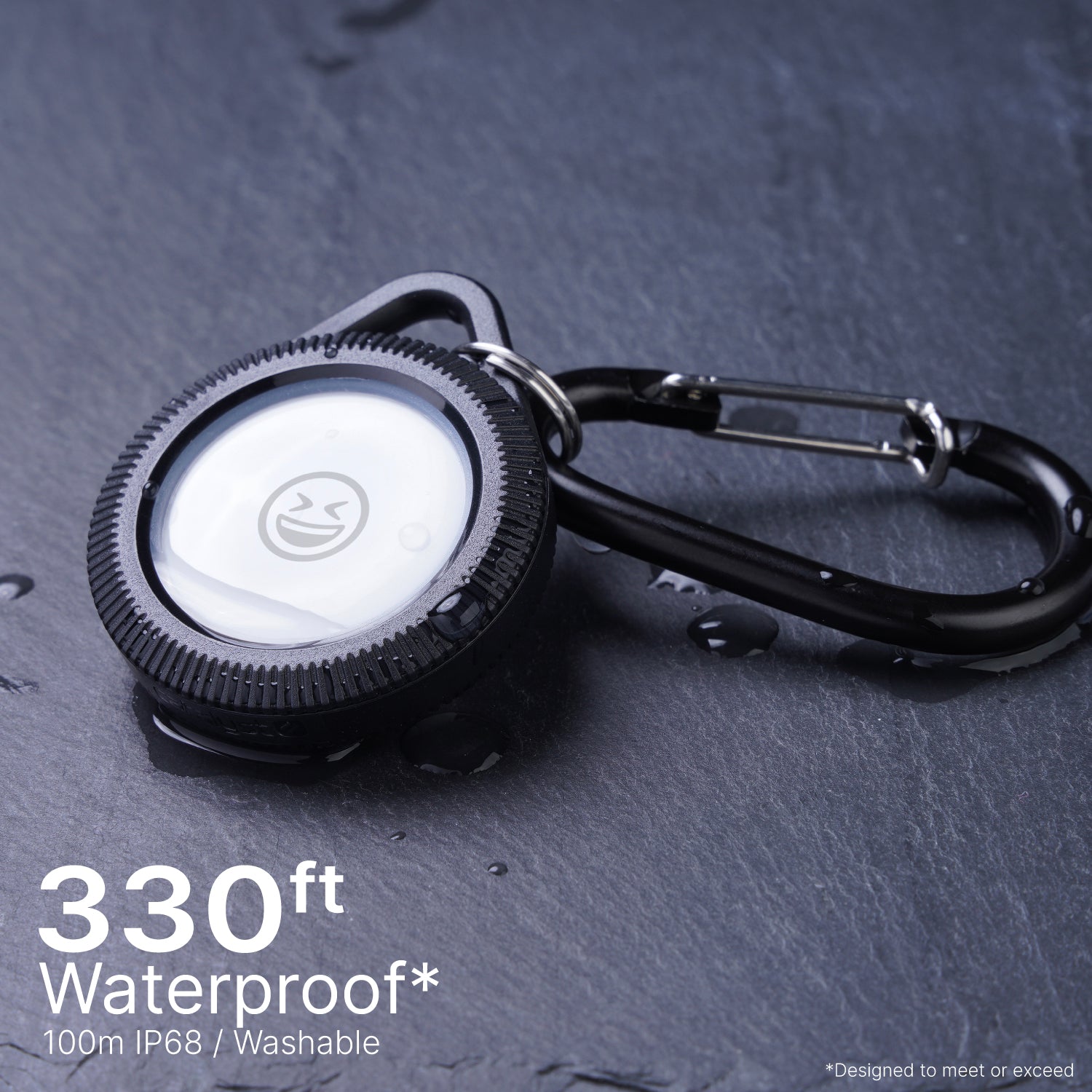 Catalyst airtag total protection case hang it with carabiner on the floor being waterproof text read 330ft. waterproof 100m IP68/ Washable