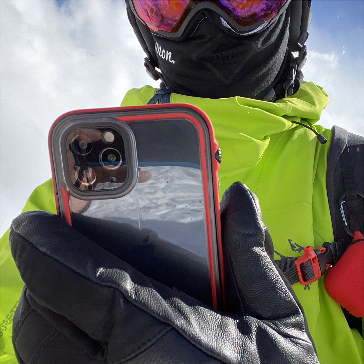 Catalyst iphone 11 series waterproof case in iphone 11 pro showing the man holding his phone with the case in a flame red colorway.